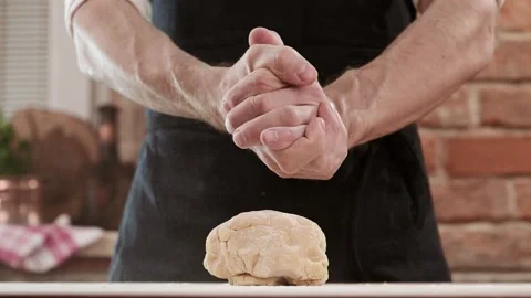 Bakers hands clap their hands filled with flour on a black background. The baker Stock Footage 150768033