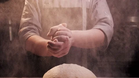 Bakers hands clap their hands filled with flour on a black background. The baker Stock Footage 150768141