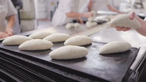 Baker's hands make bread on the table out of pieces of dough. Baking, tradition Stock-Footage 98016633
