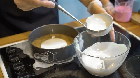 Baker's hands pour the dough into a baking dish Stock Footage 119664218