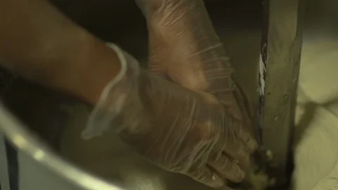 Bakers hands stretch dough in slow motion Stock Footage 128460550