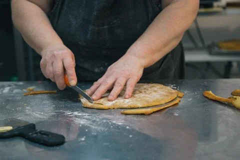 Baker’s Hands Trimming Cake Layer for Napoleon Dessert Stock Photos