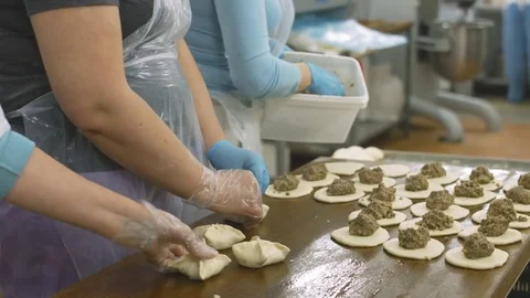 Bakers lay raw minced meat in the each of piece of dough Stock Footage 77724403