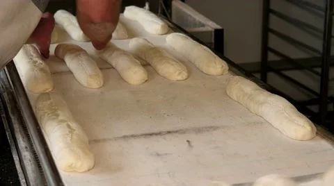 Bakers preparing the bread dough before placing in hot oven Stock Footage 64470647