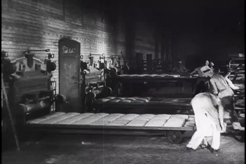 Bakers put bread in ovens to bake and Women buy bread at a bakery - 1948 Video stock 100287142