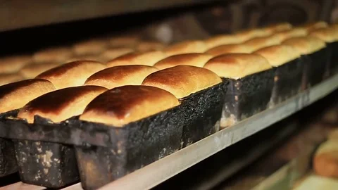 Bakery. Baked bread moves along the conveyor Video stock 74394417