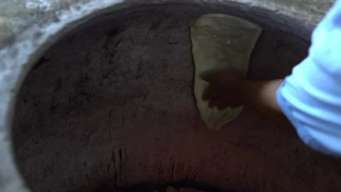 In the bakery, the baker prepares whole grain bread in the oven Stock Footage 234830355