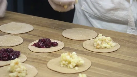 In the bakery bakers spread the stuffing on the pens 스톡 동영상 70004302