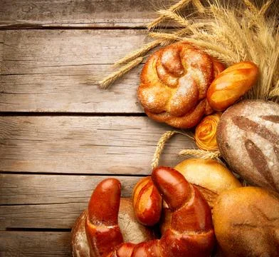 Bakery Bread and Sheaf over Wood Background Stock Photos