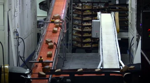 Bakery. Bread Loaves Moving on Conveyer, Stepping to the Other, Going Up. Metal Video stock 68622812