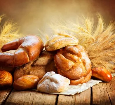 Bakery Bread on a Wooden Table. Various Bread and Sheaf Stock Photos