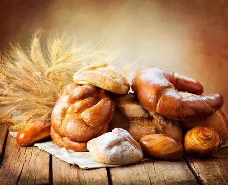 Bakery Bread on a Wooden Table. Various Bread and Sheaf Stock Photos