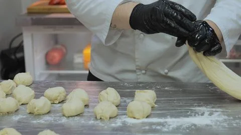 Bakery, the chef is preparing the dough, the bakery worker is preparing the Stock Photos