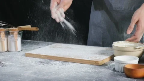 Bakery chef sprinkle white flour on the wooden tray for baking. Stock Footage 147088666