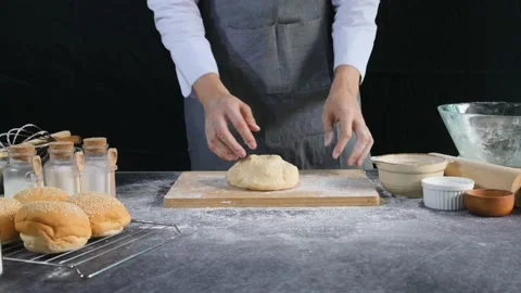 Bakery chef throws yeast dough onto bakery table and knead the dough by hand. 動画素材 147088706