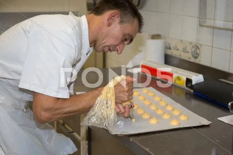 Bakery chief making macarons in the laboratory Stock Photos