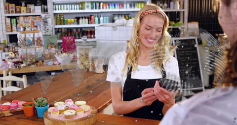 Bakery clerk processing payment after card handed, tapping POS, dotted world map Stock Footage 321550800