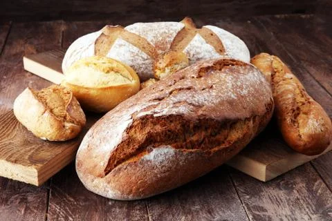 Bakery concept with bread and bread rolls on wooden background Stock Photos