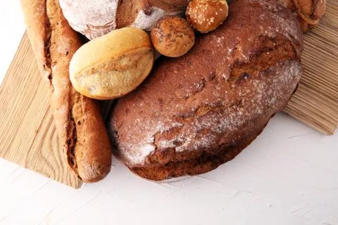 Bakery concept with bread and bread rolls on white background Stock Photos
