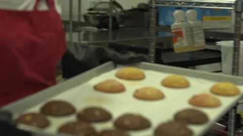 Bakery cookie sheet is carried from oven Stock Footage 128461332