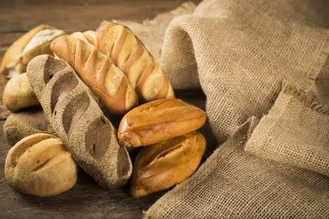 The bakery. Different types of fresh breads on the table. Stock Photos