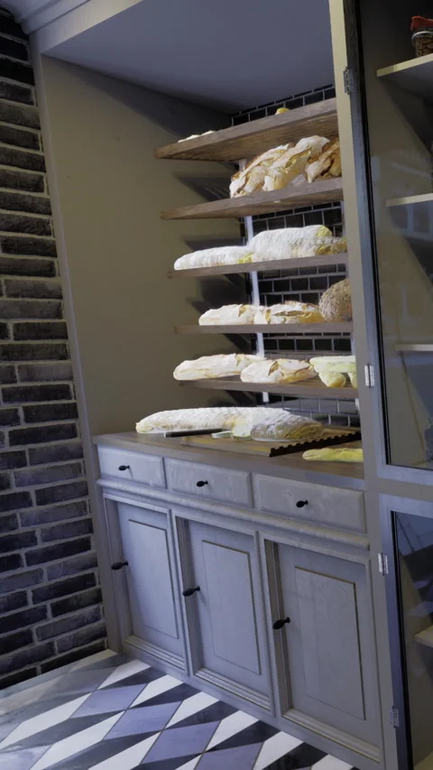 Bakery display area showing fresh bread on shelves with gray storage cabinet Stock Footage 331666937