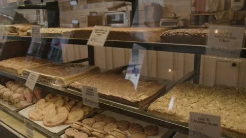 Bakery Display Case with Assorted Cakes and Pastries in Sydney Cafe Interior Stock Footage 345660432