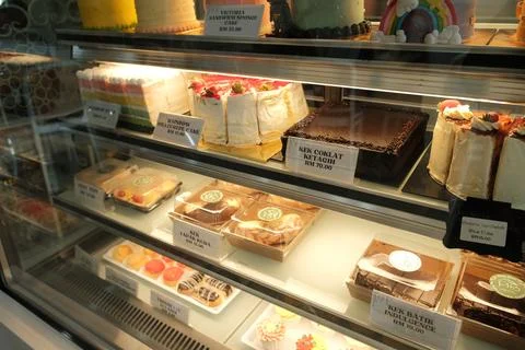 Bakery Display Case with Assorted Cakes &amp; Pastries Stock Photos