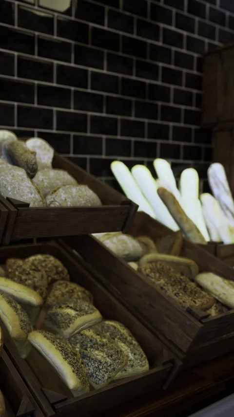 Bakery display of different types of bread arranged on wooden shelves in town 動画素材 331669010