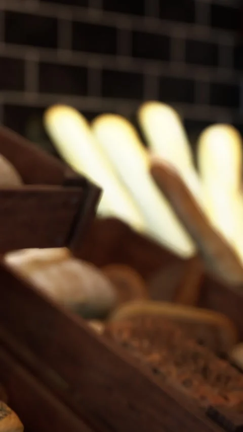Bakery display with various bread types and warm lighting Stock Footage 340646111