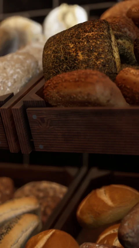 Bakery display with various types of bread and rolls in wooden baskets Stock Footage 342180601