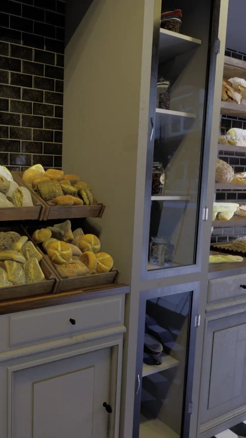 Bakery displays fresh bread and pastries in a cozy setting Stock Footage 342442461