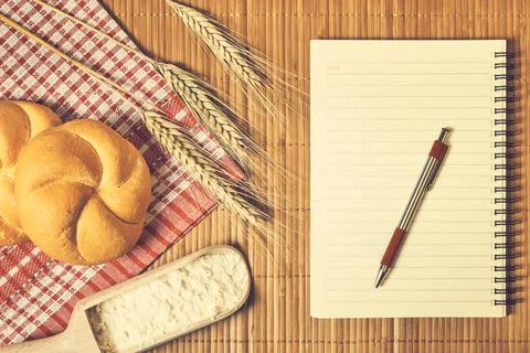 Bakery food and notebook on the table Stock Photos