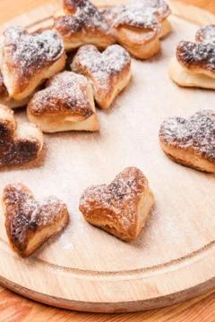 Bakery hearts from split pastry with sugar powder on wooden Stock Photos