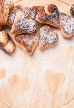 Bakery hearts from split pastry with sugar powder on wooden Stock Photos