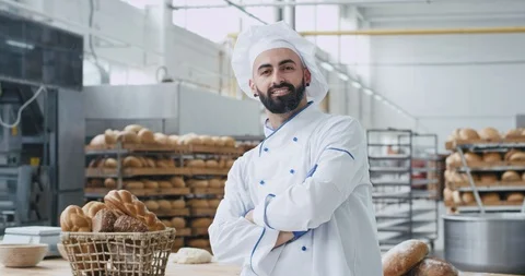 Bakery industry baker chef man with a beard looking straight to the camera Stock Footage 112139691