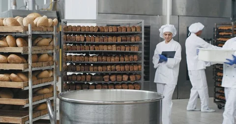 Bakery industry big chef in a special uniform preparing the dough add some flour Stock Footage 112144312