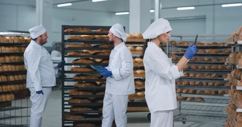 Bakery industry large video taking three bakers chatting with each other tone Stock Footage 122935356
