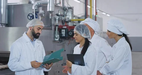 Bakery industry man engineer his assistance and baker chef and young baker lady Stock Footage 112150836