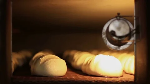 Bakery. Loaves are baked in the oven Stockbeeldmateriaal 74394251