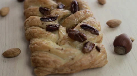 Bakery. Macro of cake with nuts spinning on the wooden table Video stock 60944246