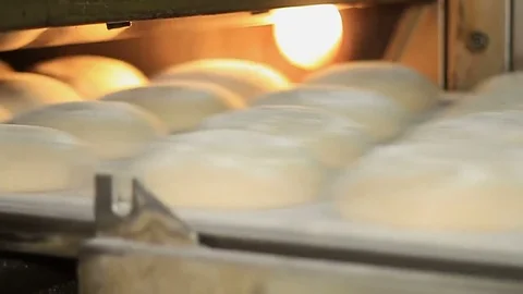 Bakery. The man inserts a plate with the formed bread into the oven. Close-up. Stock Footage 74393695