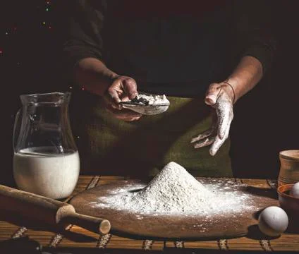 Bakery. Man preparing bread, Easter cake, Easter bread or cross-buns on woode 写真素材