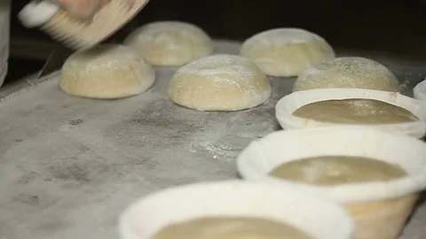 Bakery. Men lay out the formed bread from the forms on the plate. Video stock 74393766