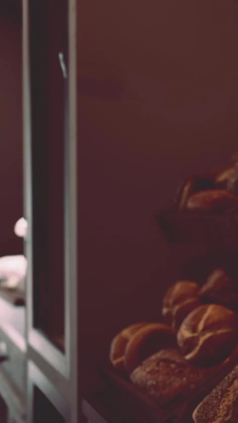 Bakery scene with fresh bread displayed on a shelf in a shop setting Stock Footage 340638972