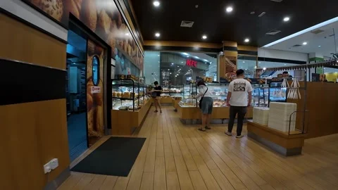 Bakery Shop Inside aeon mall with Customers Browsing Fresh Pastries Stock Footage 348799731