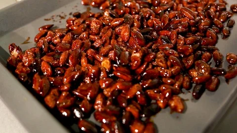 Bakery tray with roasted almonds in sugar Stock Footage 115286156