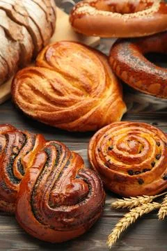 Bakery - various kinds of breadstuff. Bread rolls, bagel, sweet bun. Vertical Stock Photos