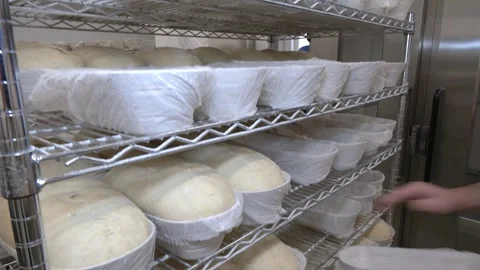 Bakery Worker Arranging Proofing Baskets on Metal Rack Stock Footage 346473204