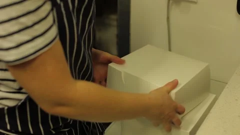 Bakery Worker Packing Decorated Layered Cakes in Boxes in Sydney Commercial Stock Footage 345691357